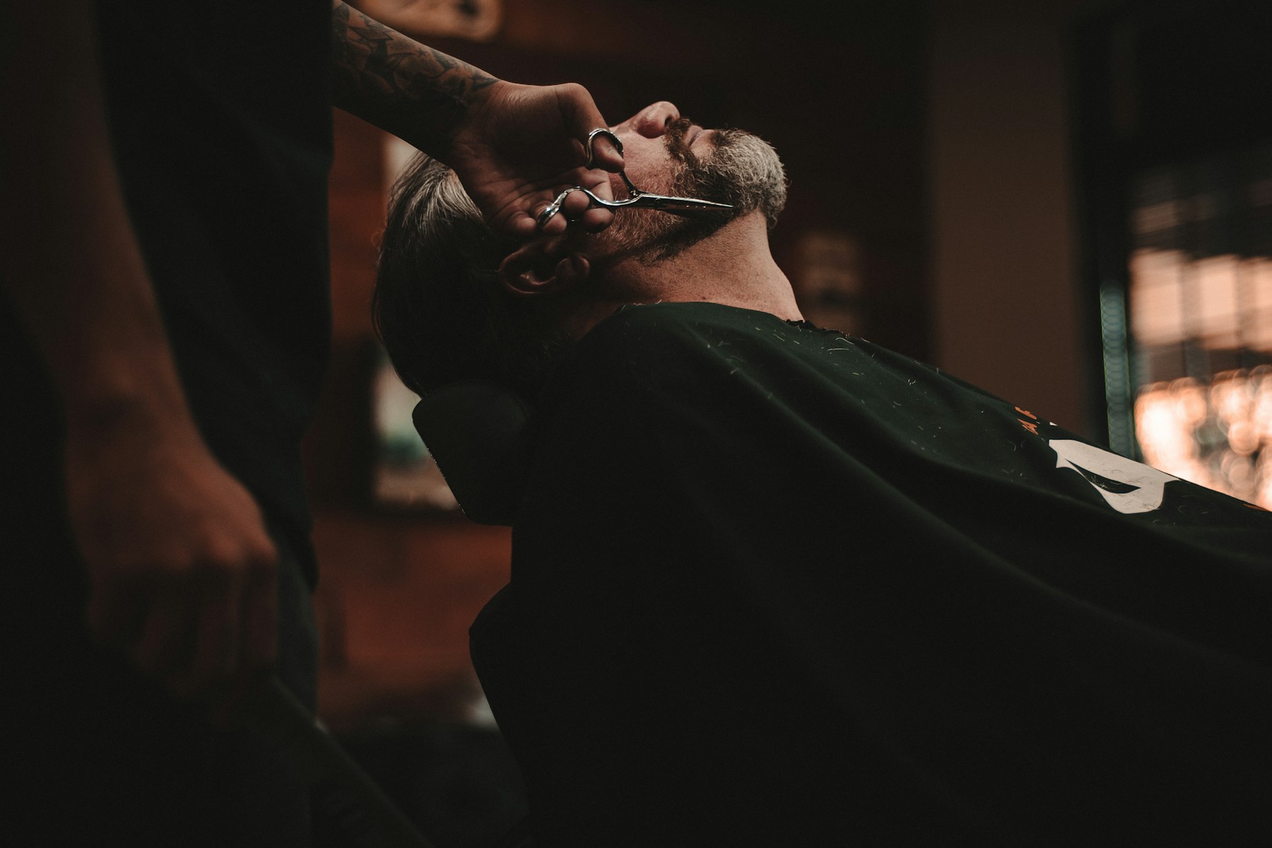 A traditional barbershop interior — wood, leather, brass